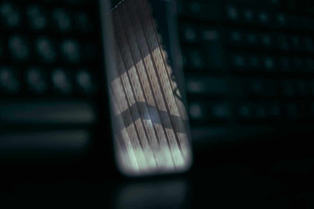 A close-up of a magnifying glass held over a computer screen displaying a digital property deed, focusing on fine print to signify the search for data inconsistencies.